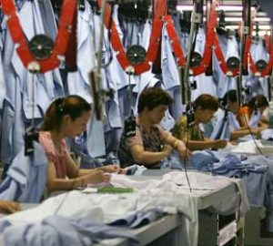 Photo of women working, sewing in a factory.